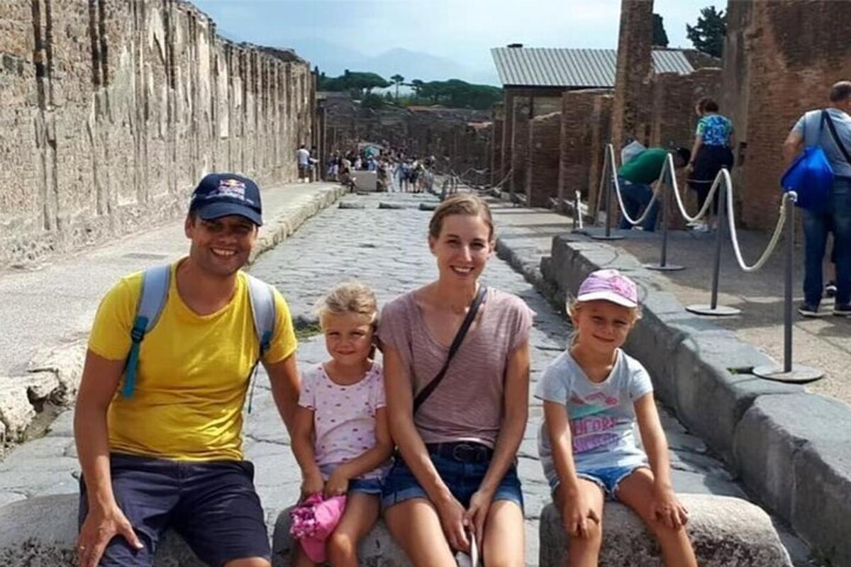 Μια οικογένεια ποζάρει για μια φωτογραφία μπροστά σε μια παιδική χαρά