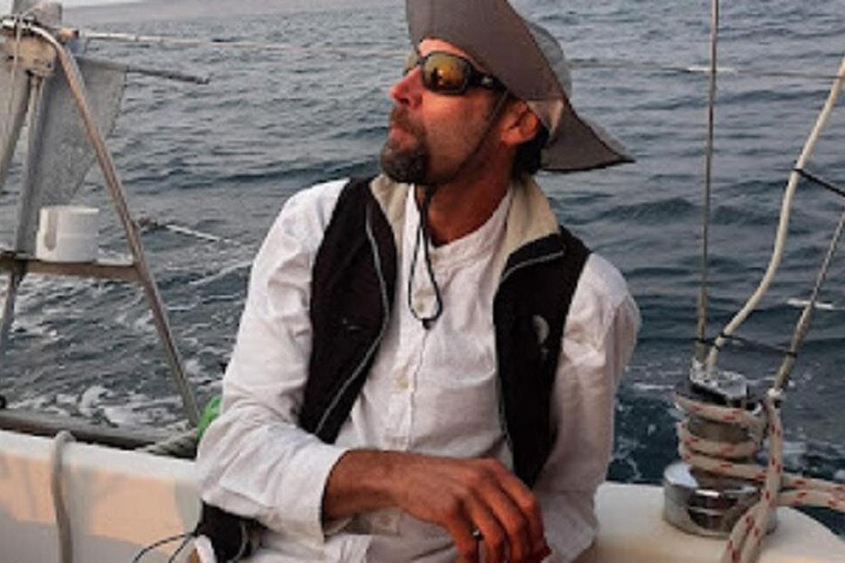 a man wearing a hat sitting on a boat