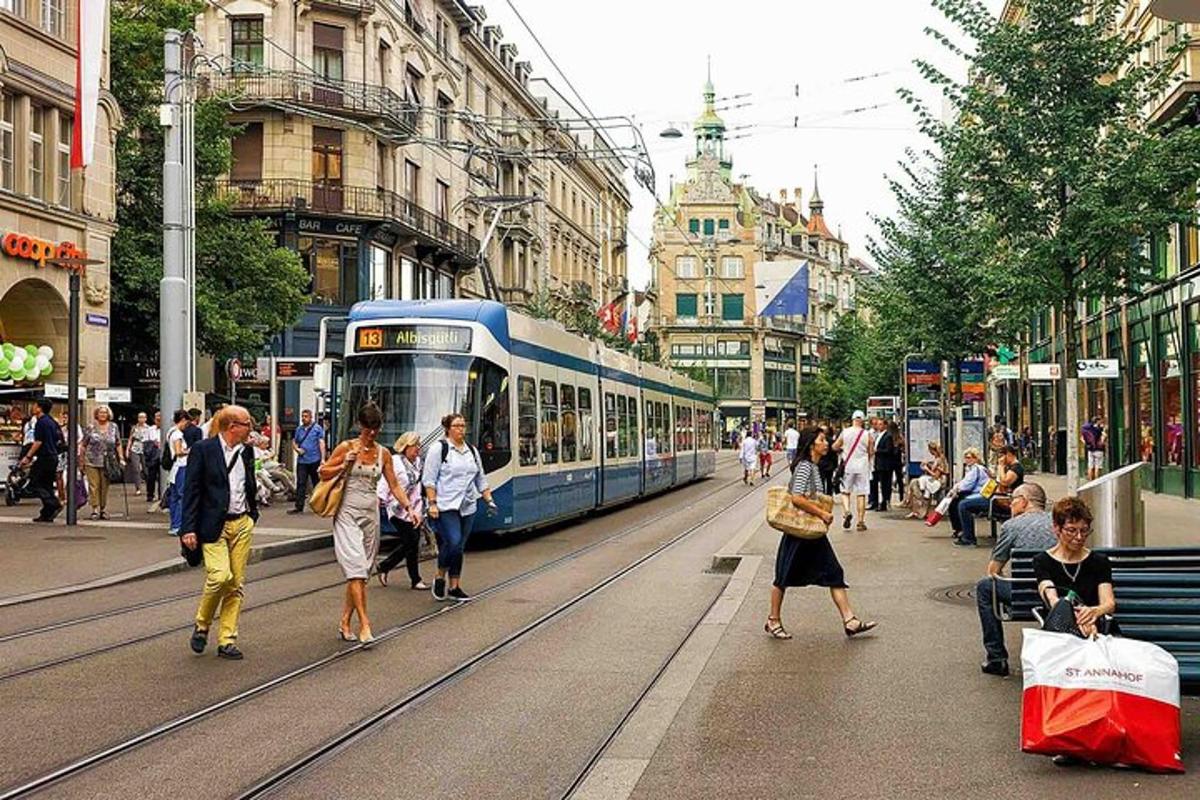 people walking on a busy city street with a tram