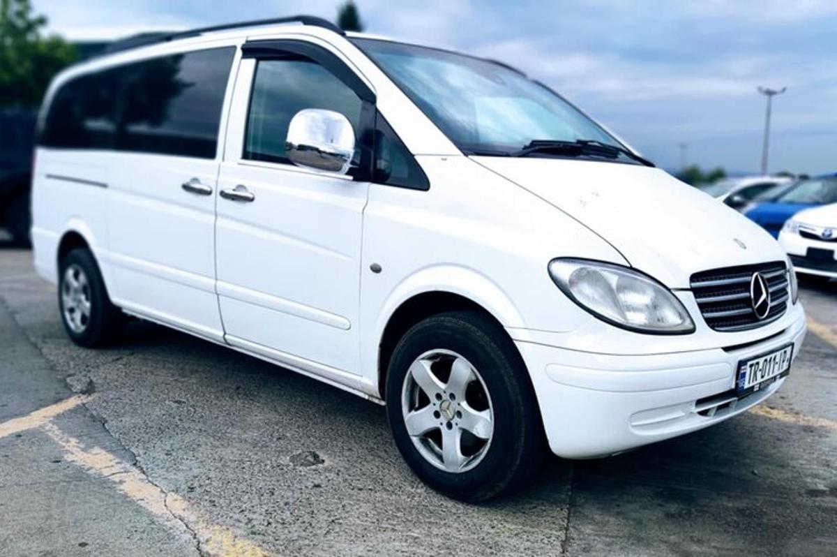 sebuah mobil van putih diparkir di tempat parkir