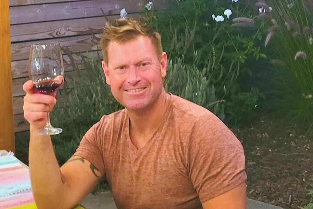 Un hombre sostiene una copa de vino.