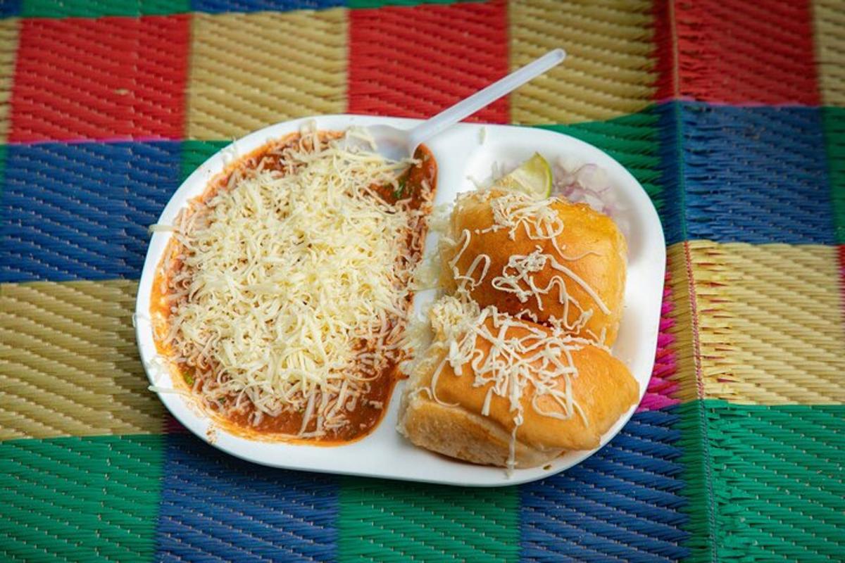 a plate of food with two hot dogs and cheese