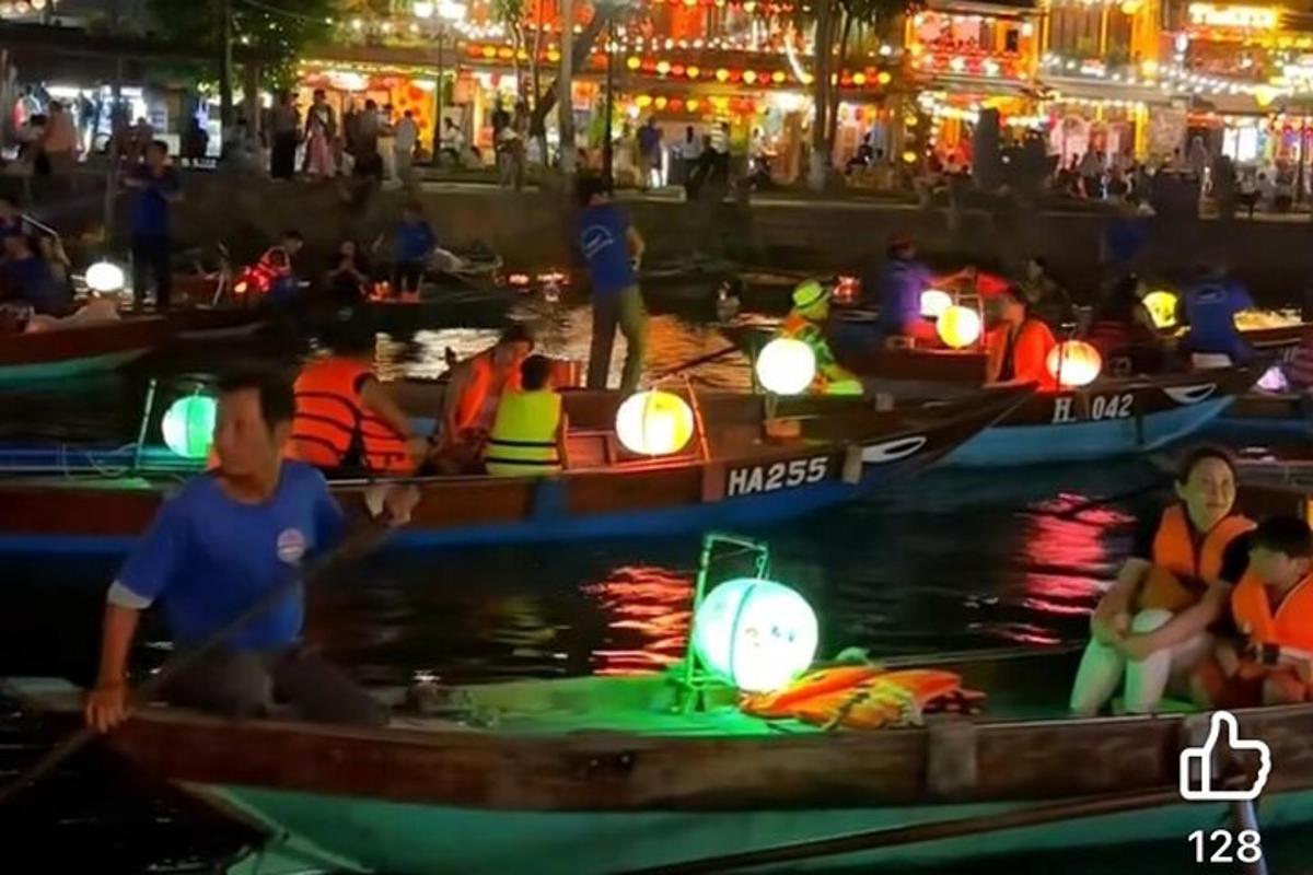 a group of people in boats in the water at night