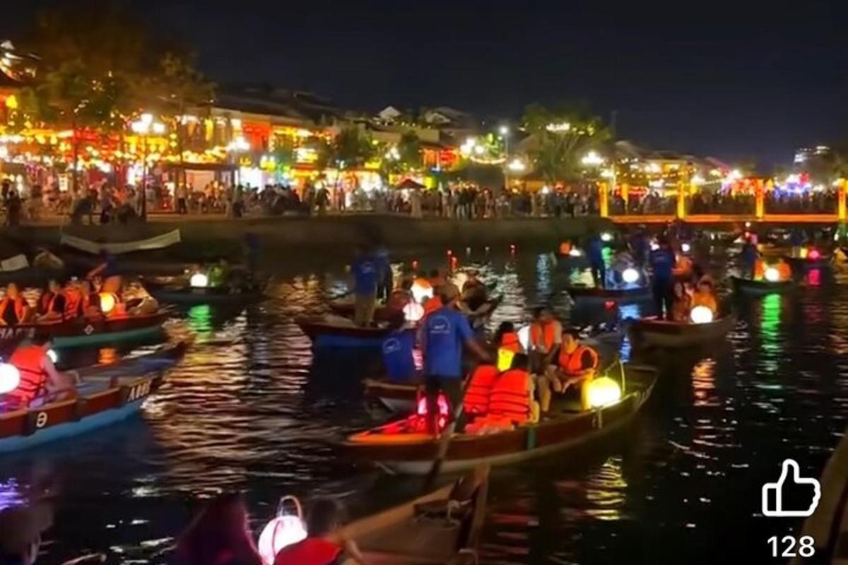 a group of people in boats on the water at night
