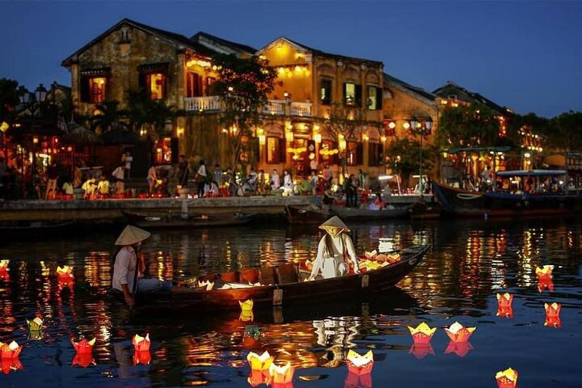 a couple in a boat on the water at night