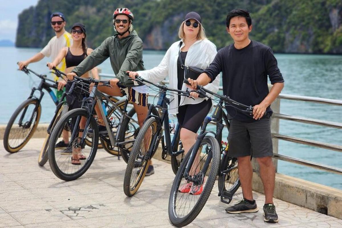 un grup de persones dempeus amb les seves bicicletes en un pont