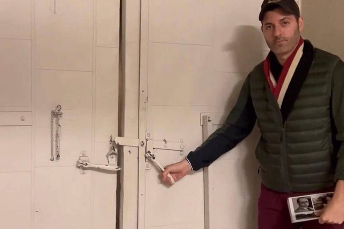 a man opening a door with a pair of scissors