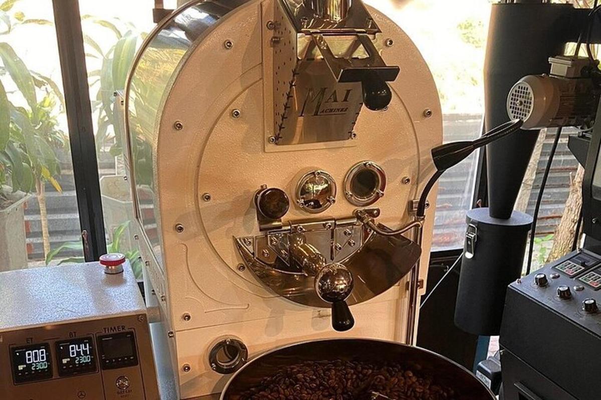 a large machine with a pot of coffee in a room