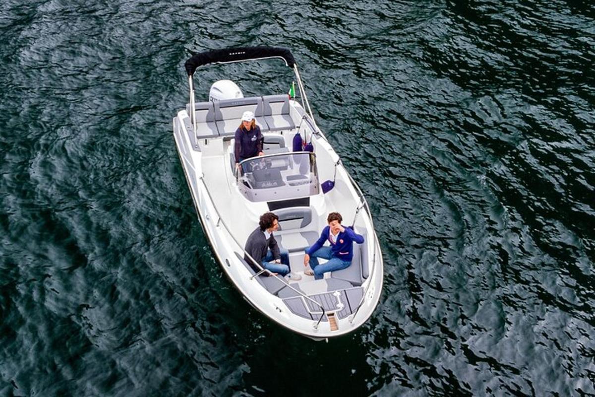 three people in a small boat in the water