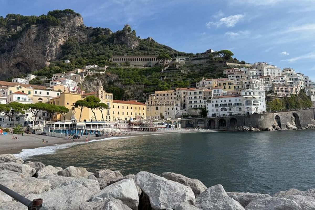 a view of a beach with buildings on a mountain