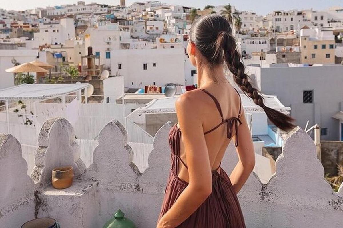 a woman in a dress looking at the city