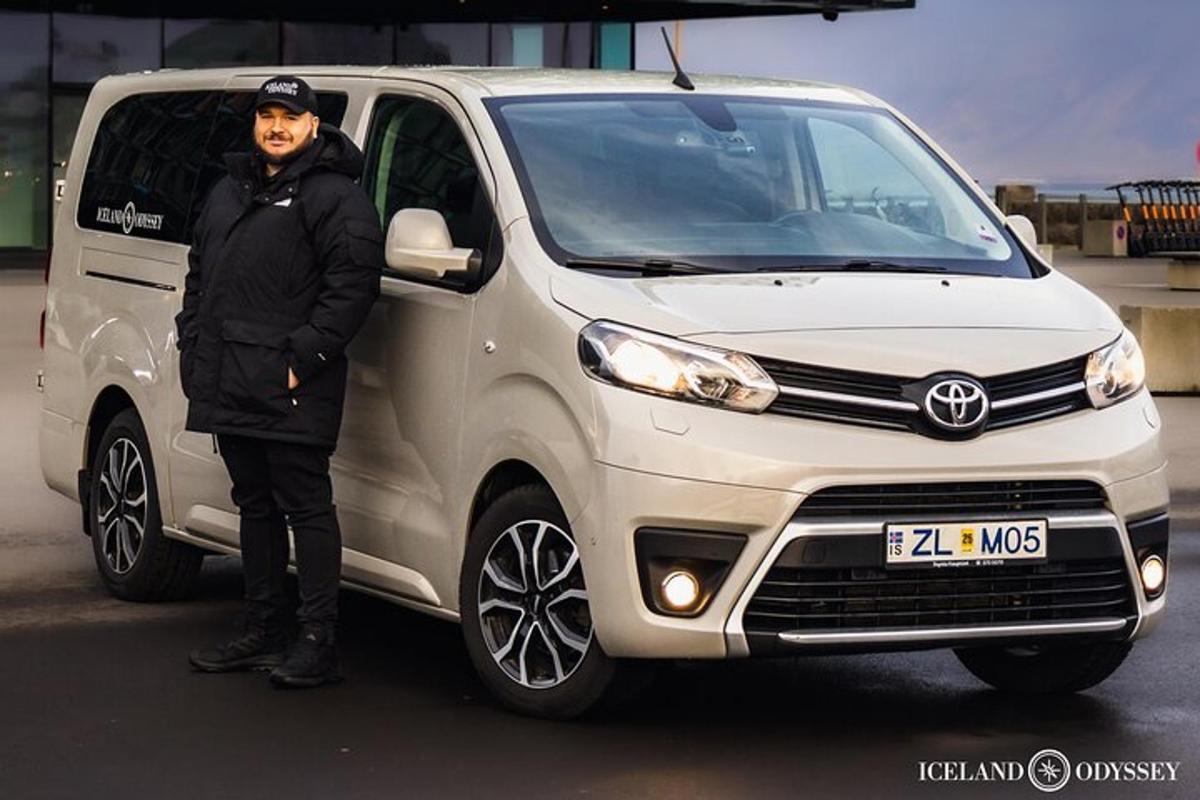 a man is standing next to a white van