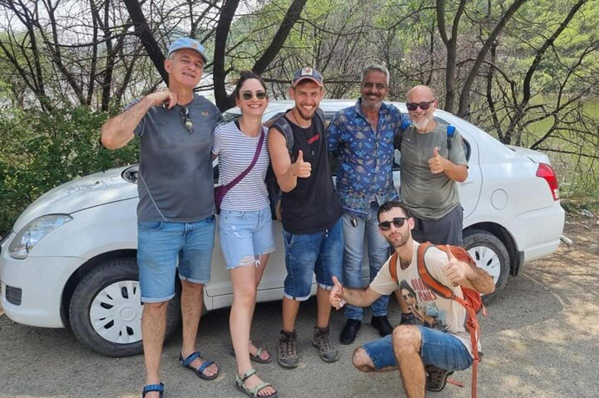 a group of people standing next to a car