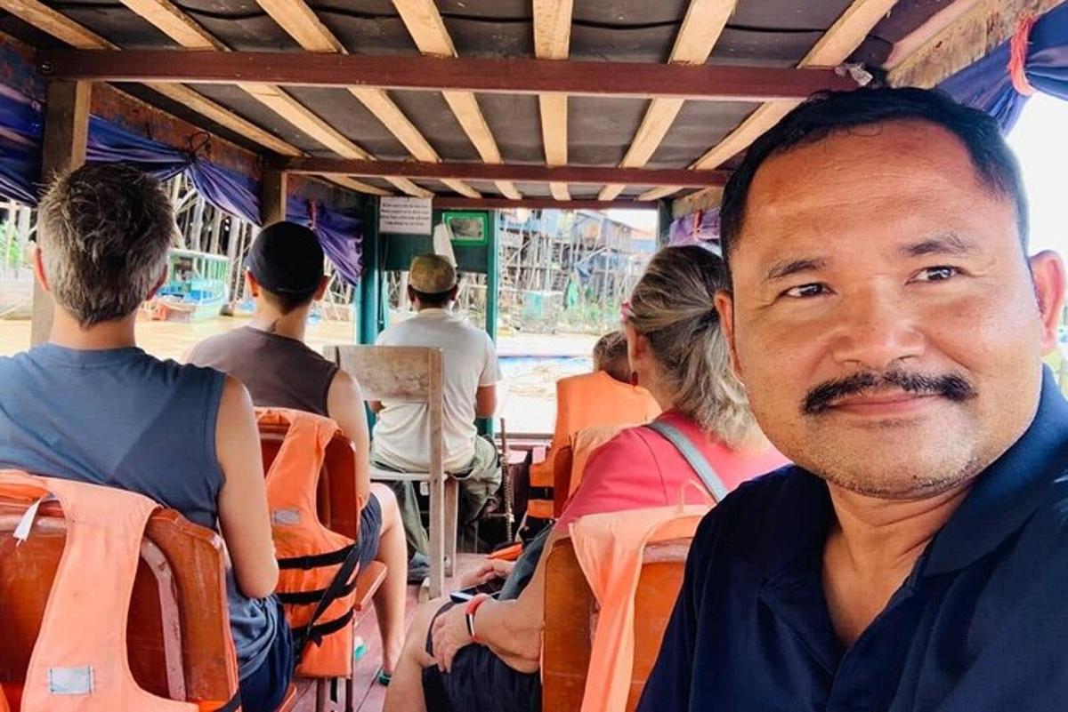 un uomo seduto su un autobus con altre persone sullo sfondo