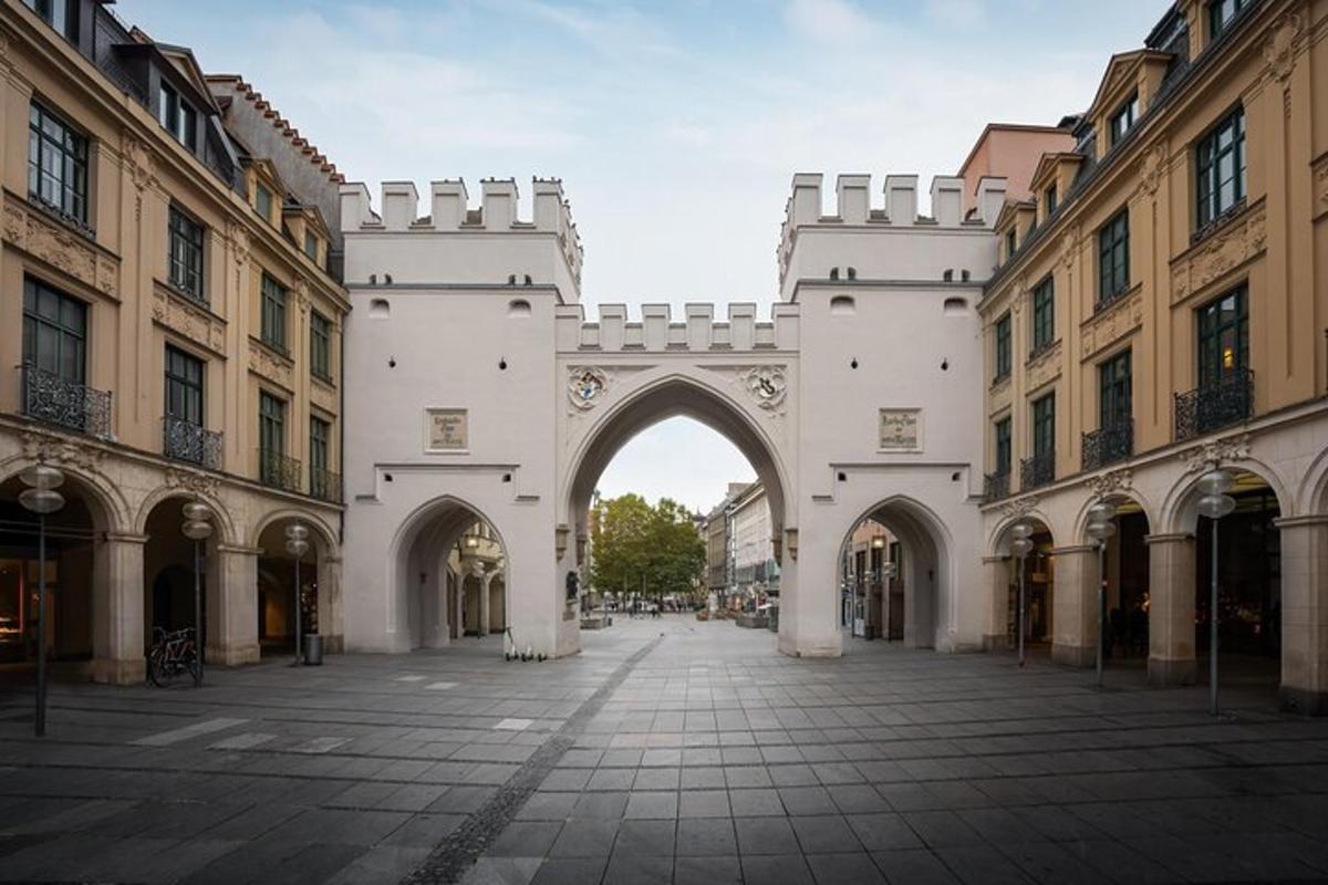 an archway in the middle of a courtyard with buildings