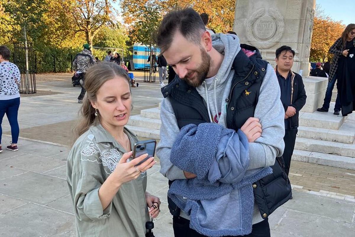 a man and a woman looking at a cell phone