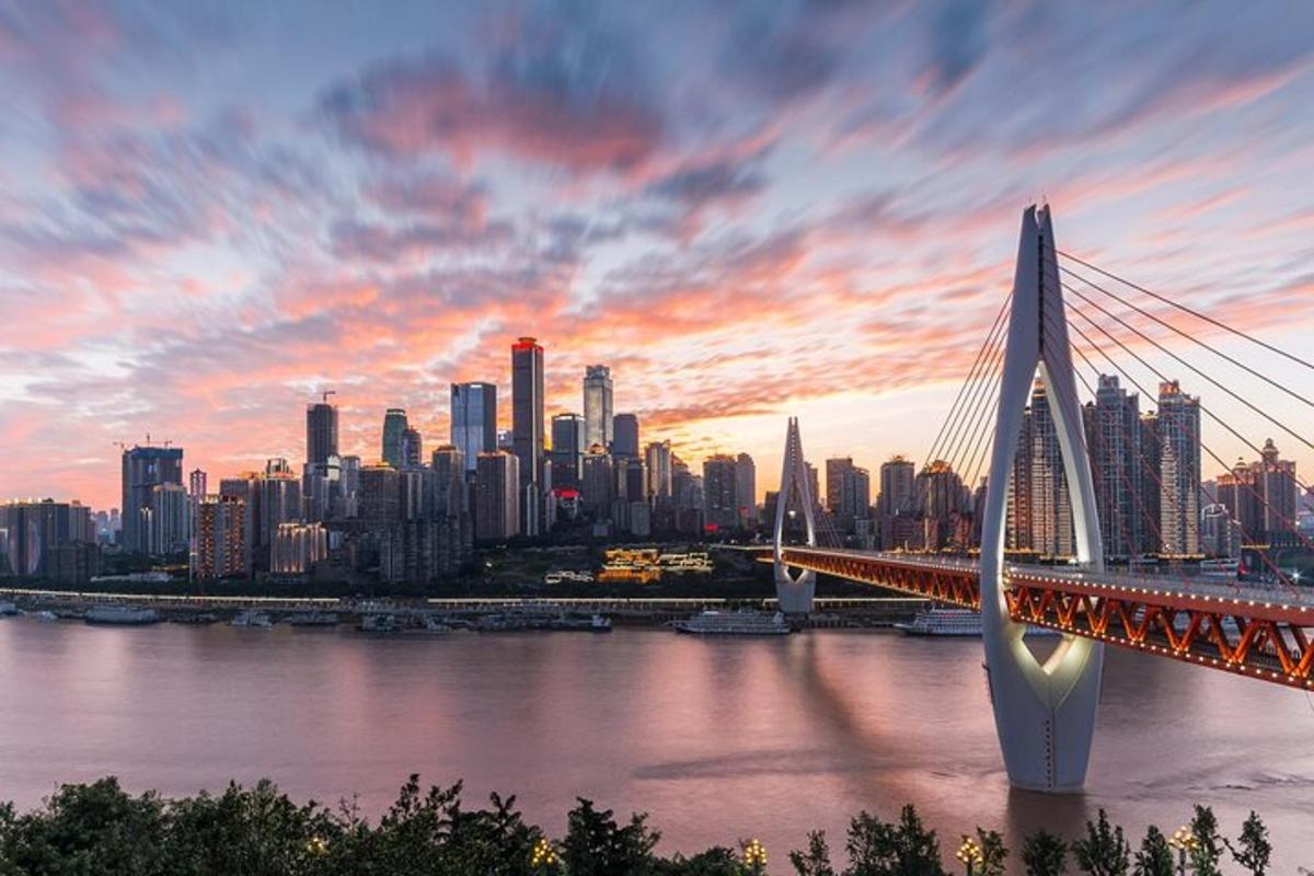 a bridge over a river with a city in the background