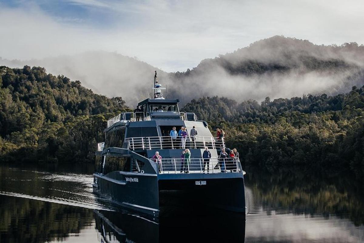 a large boat on a river with people on it