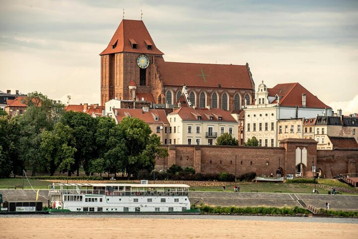 a building with a clock tower next to a river