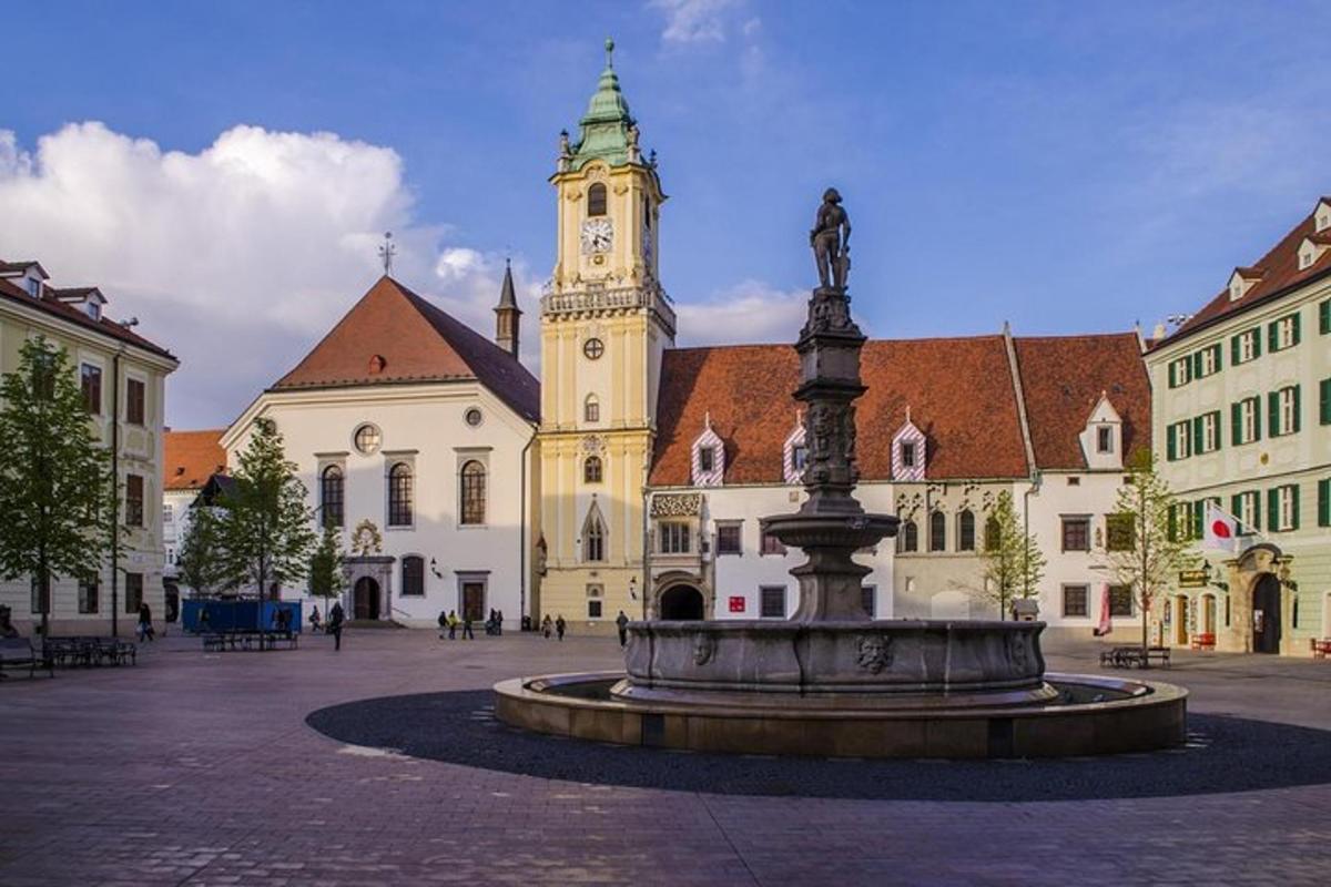 a fountain in front of a building with a clock tower