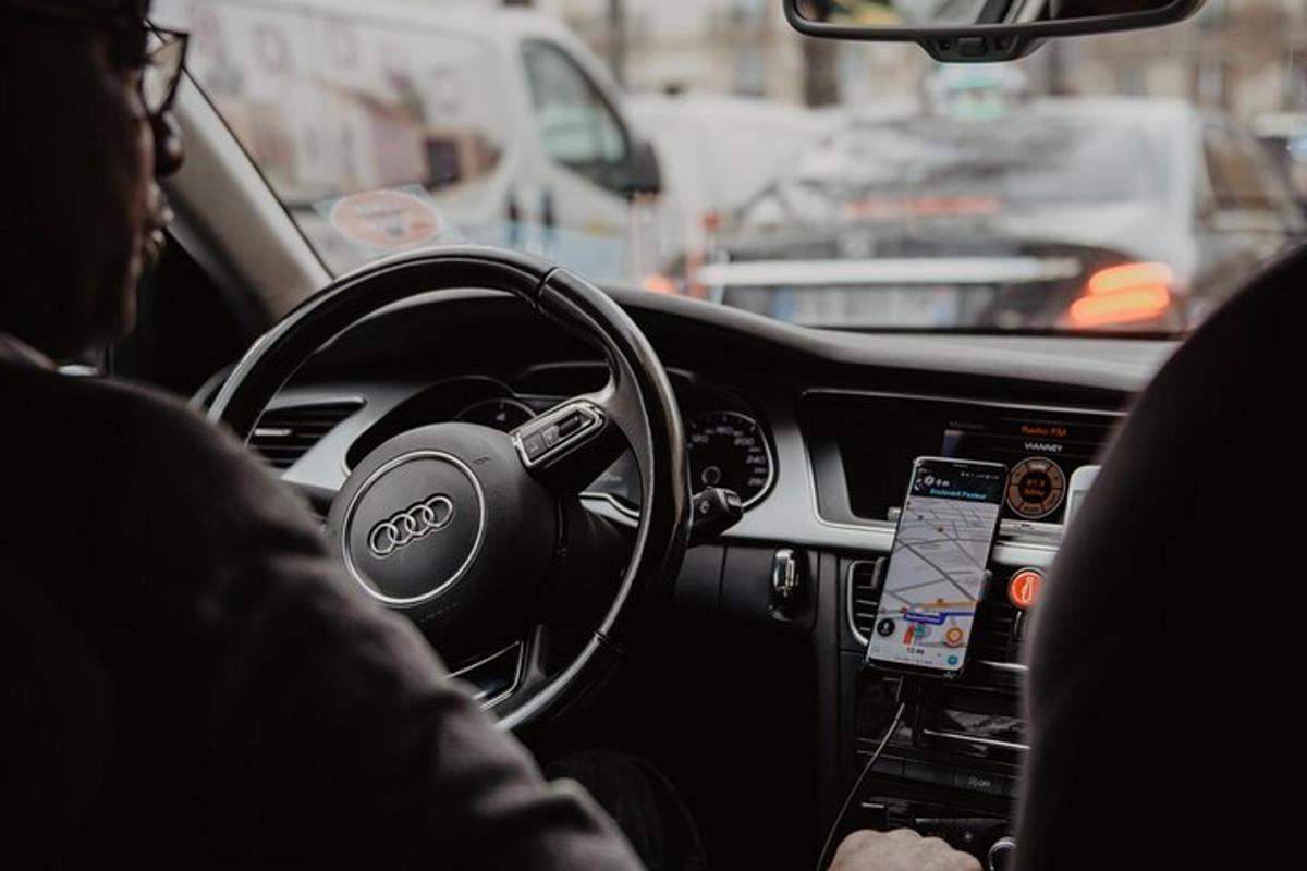 a man driving a car on a city street