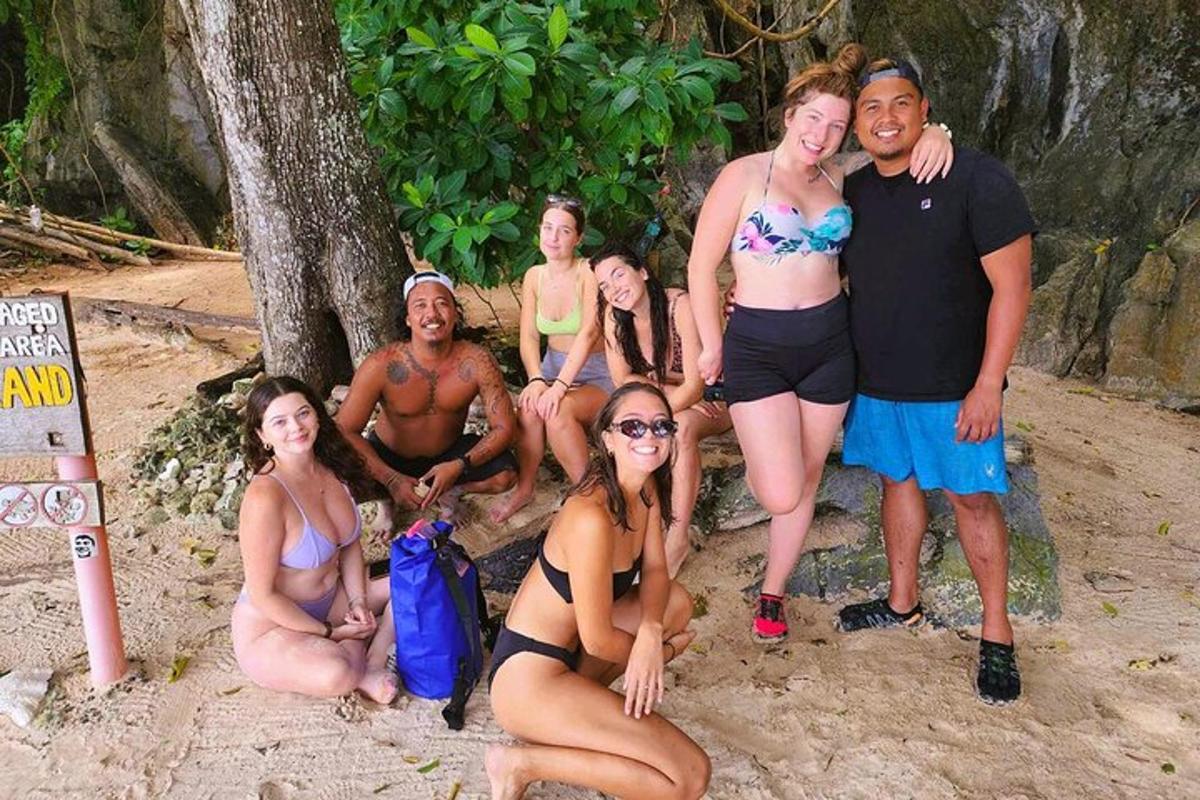 a group of people posing for a picture on the beach