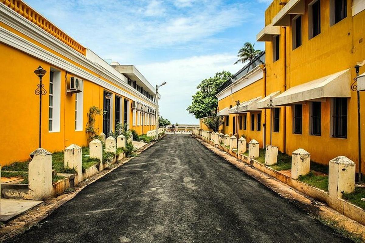 an empty street with yellow buildings on either side