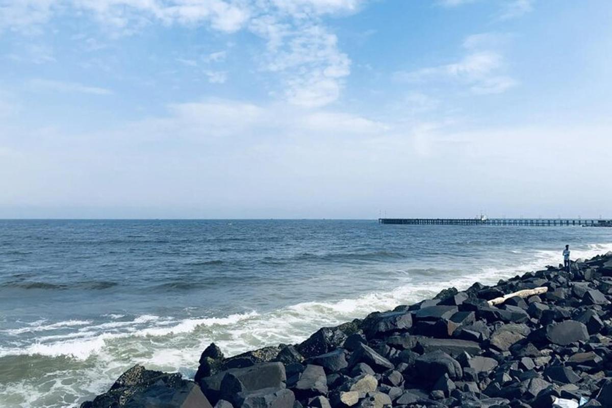 a person standing on the rocks near the ocean