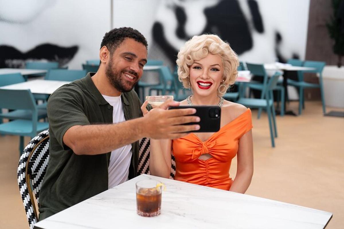 Ein Mann und eine Frau sitzen an einem Tisch und schauen auf ein Mobiltelefon