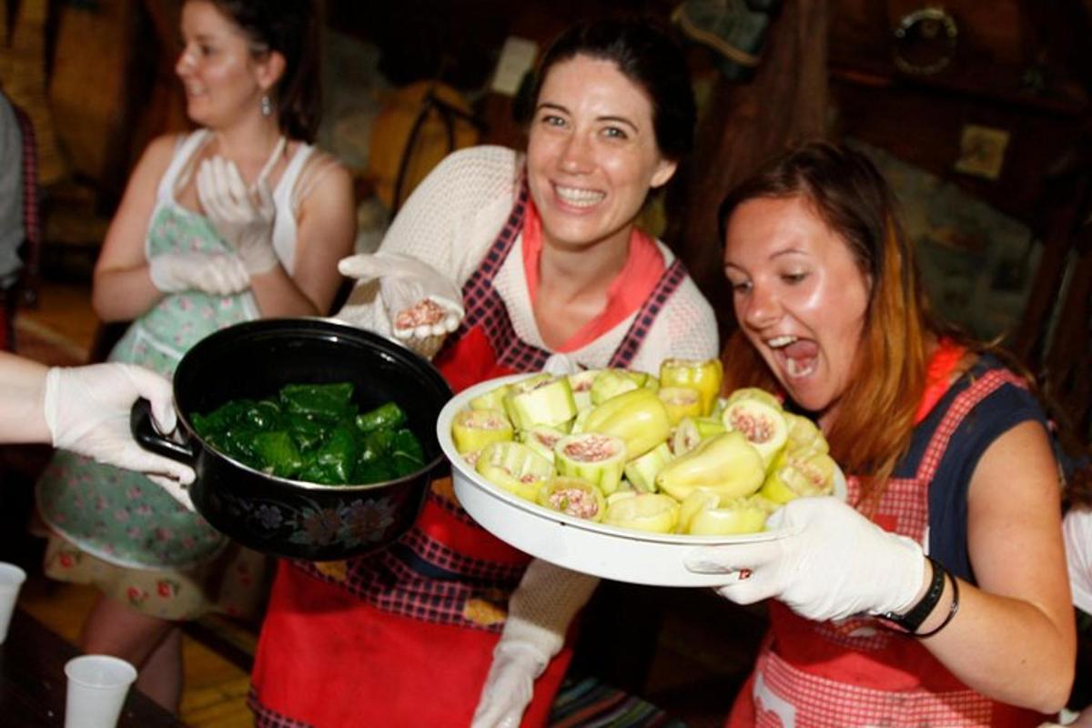 two women are holding a bowl of vegetables