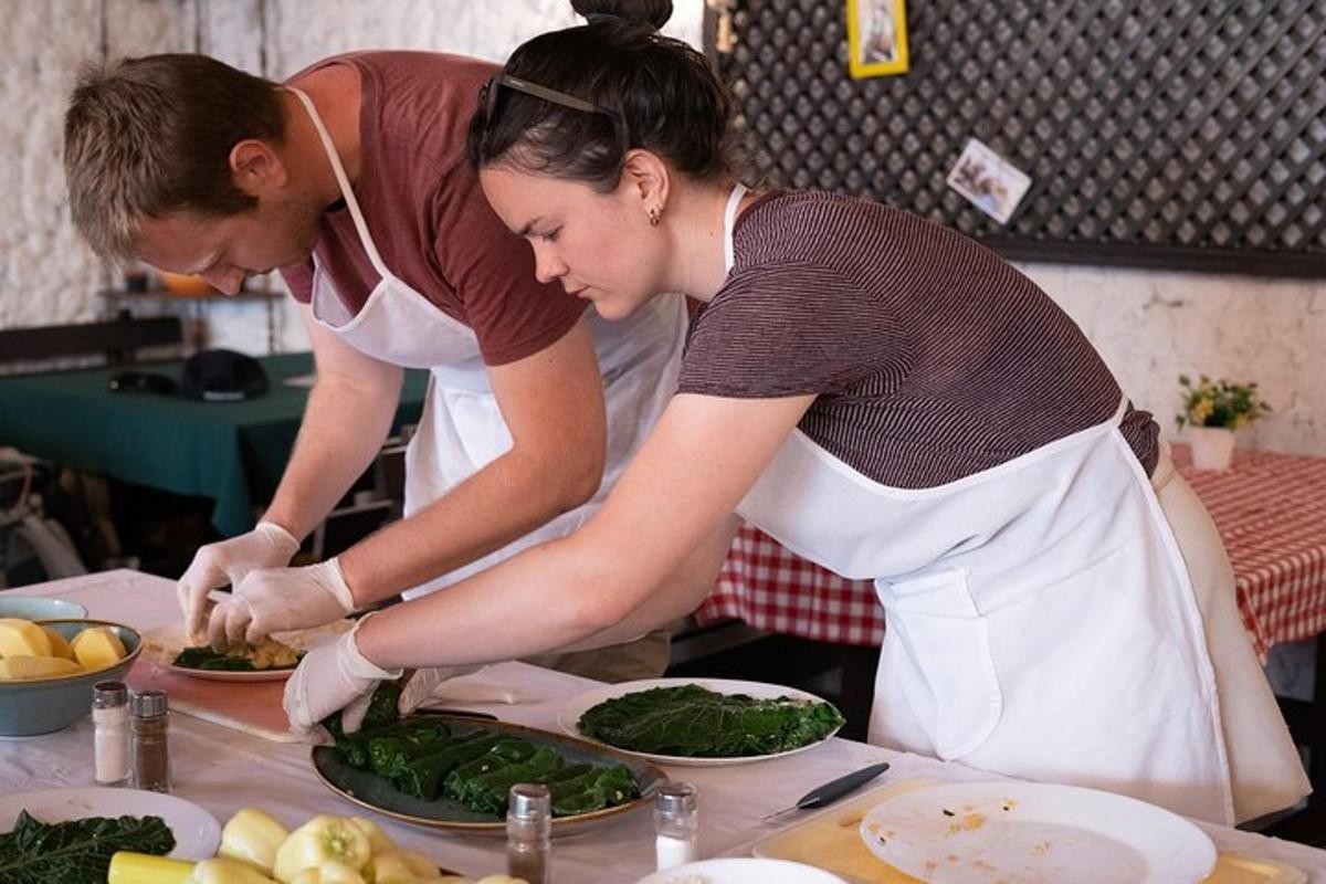 a man and woman preparing food in a kitchen