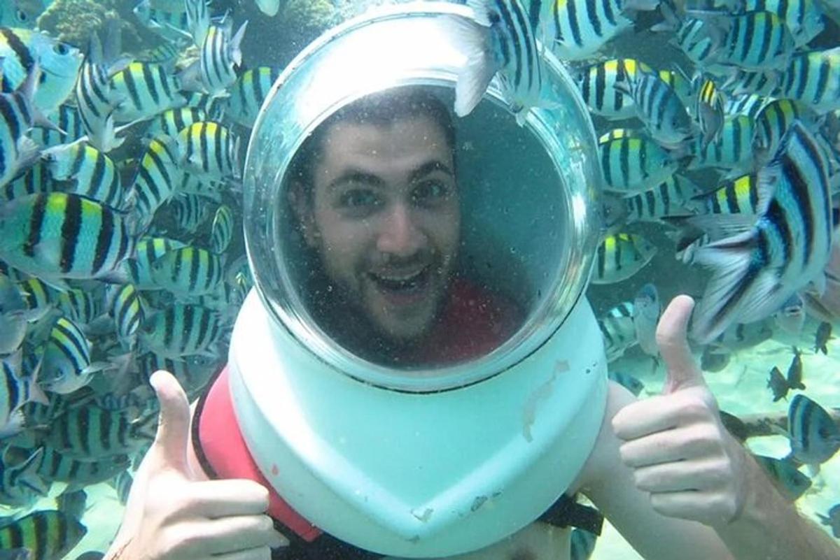 a man is holding up his reflection in a diver mirror