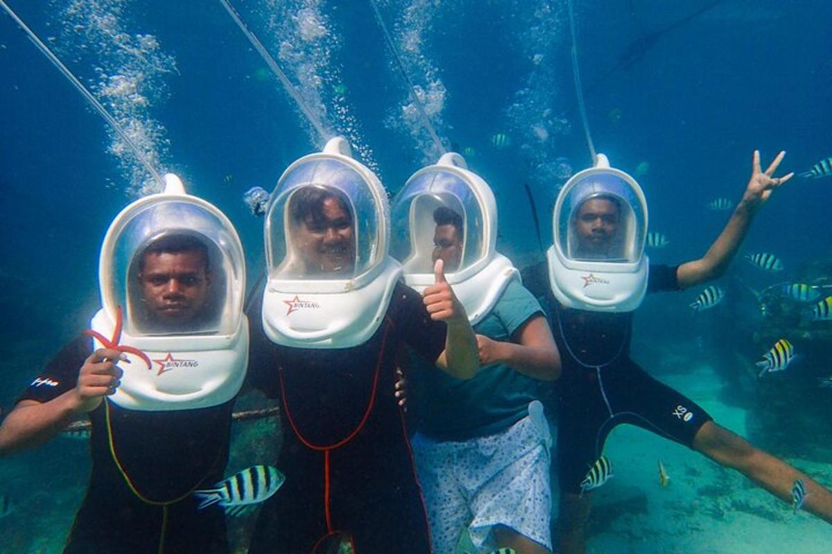 a group of three people in an aquarium wearing helmets