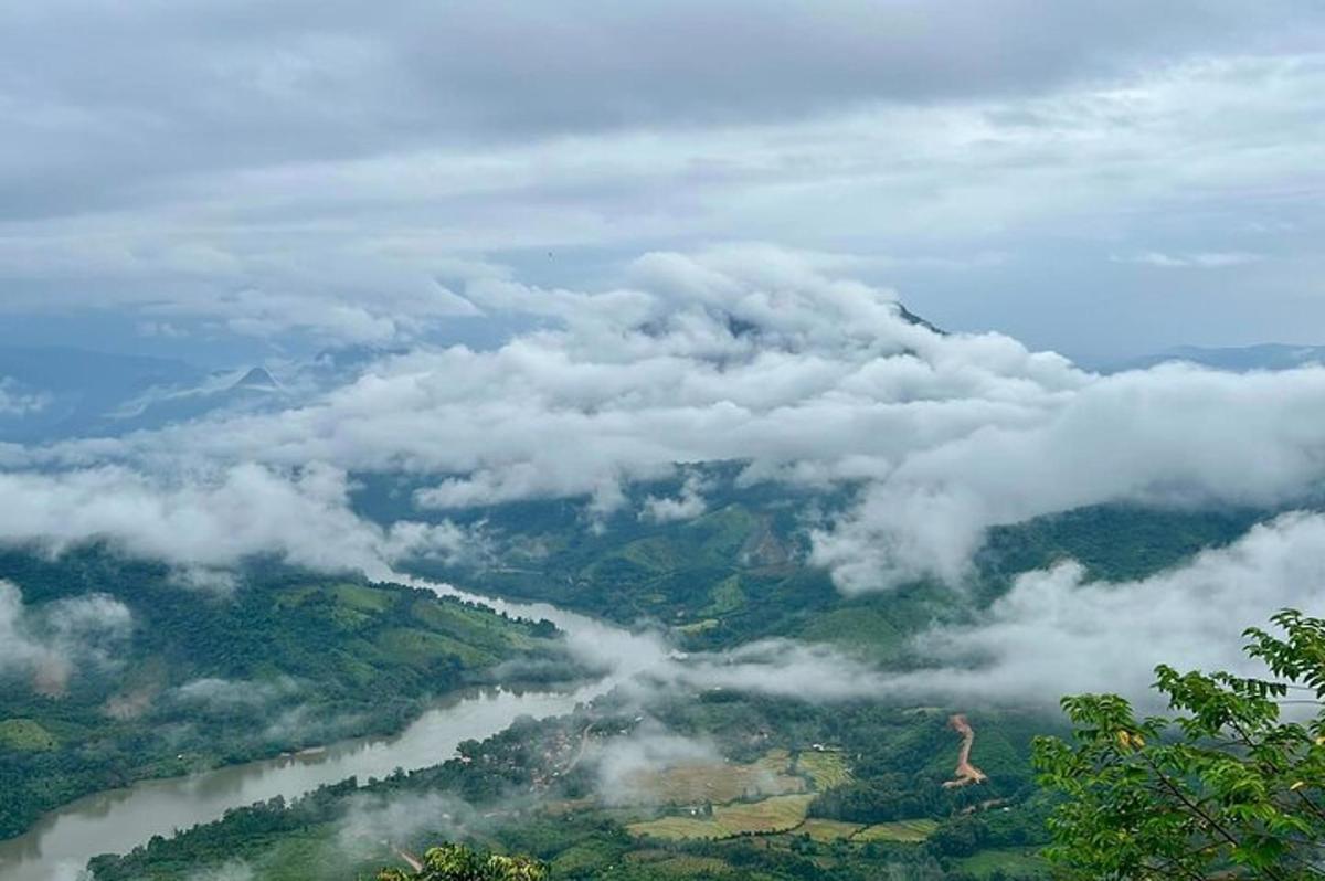 a view of a valley of clouds and a river