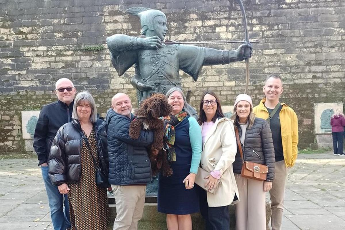 a group of people standing in front of a statue