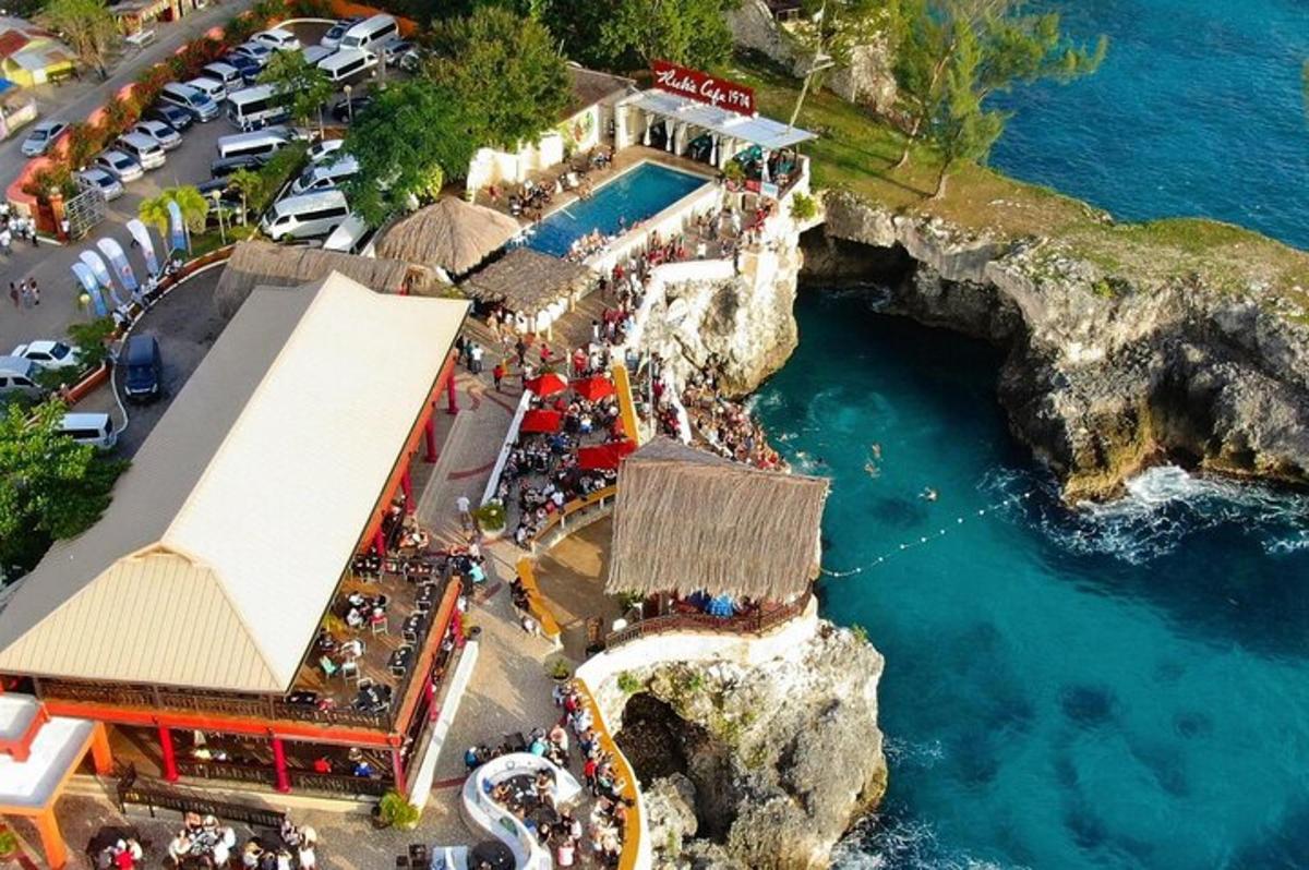 an aerial view of a restaurant on a cliff near the water