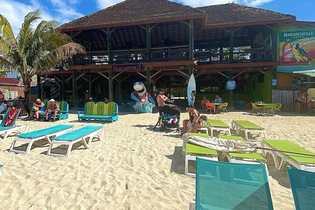 a beach with chairs and people sitting on the sand