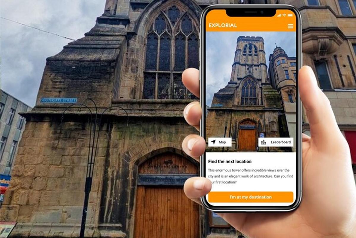 egy személy mobiltelefont tart a kezében egy templom előtt