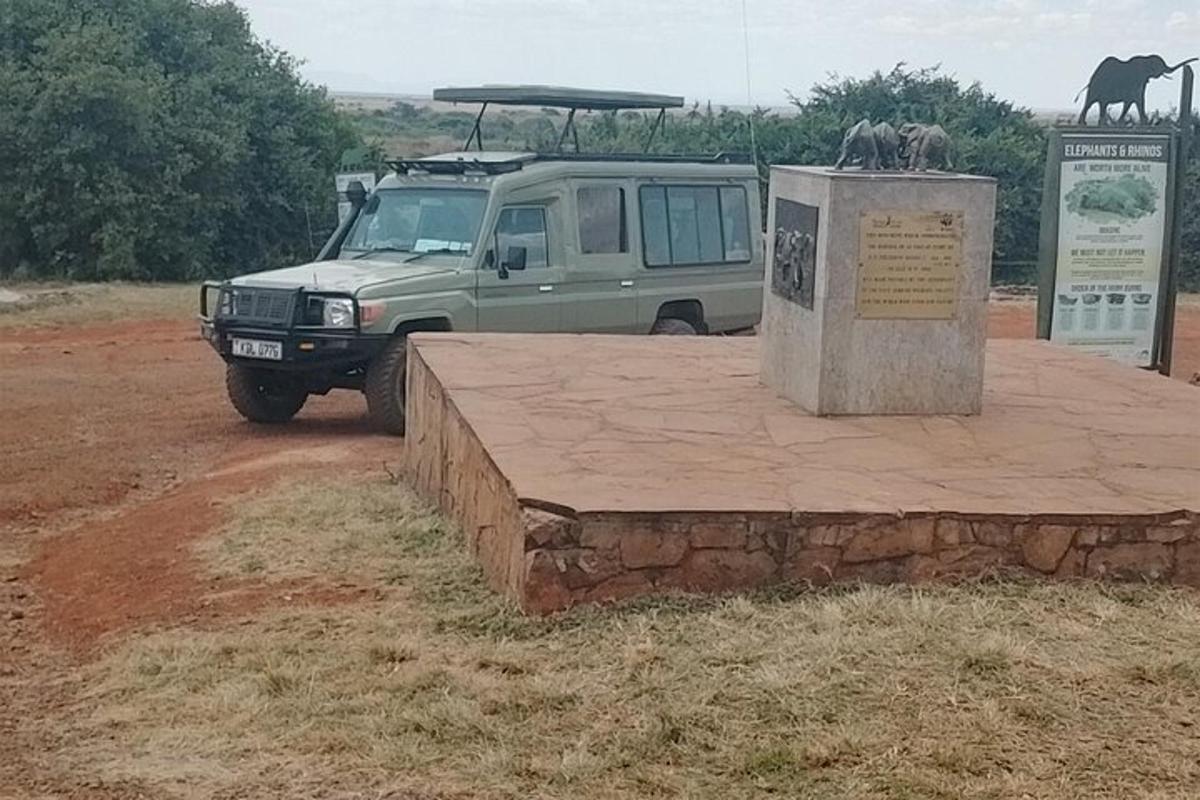 a van parked in front of a sign with animals