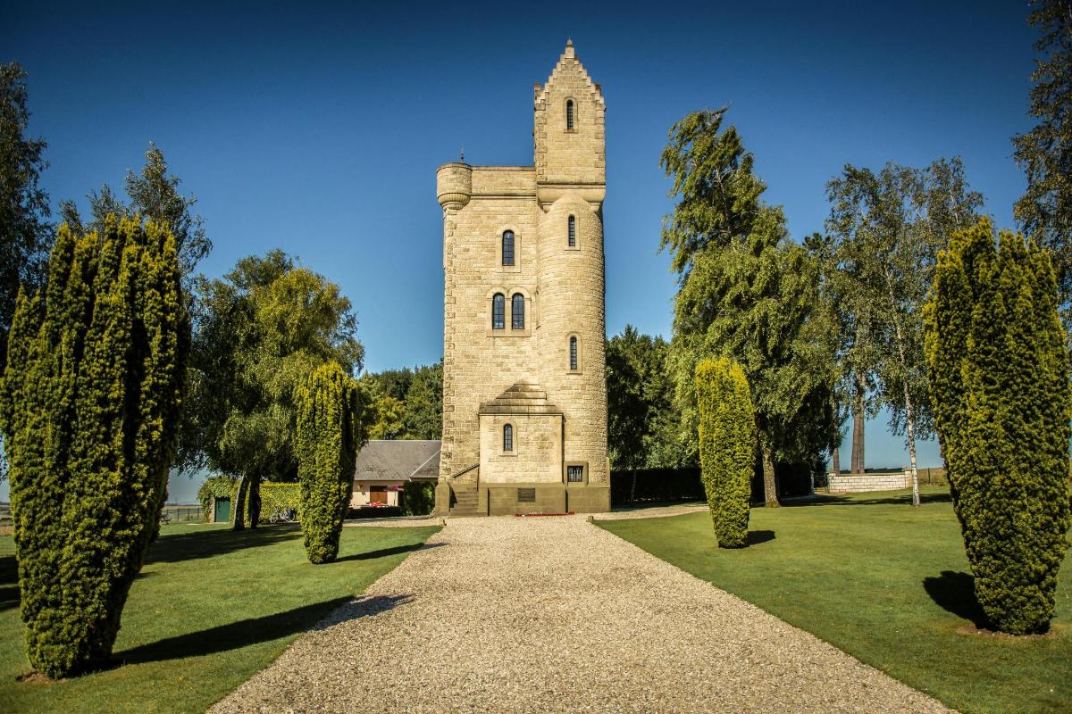 a building with a tower in a park with trees