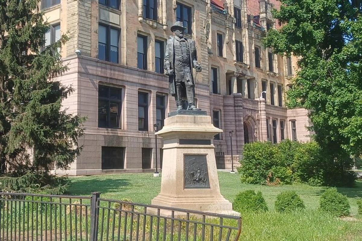 a statue of a man standing in front of a building