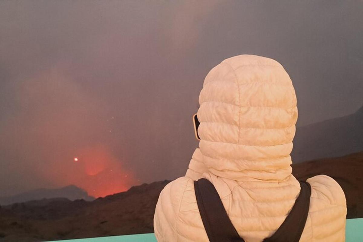 a person looking out at a fire in the distance