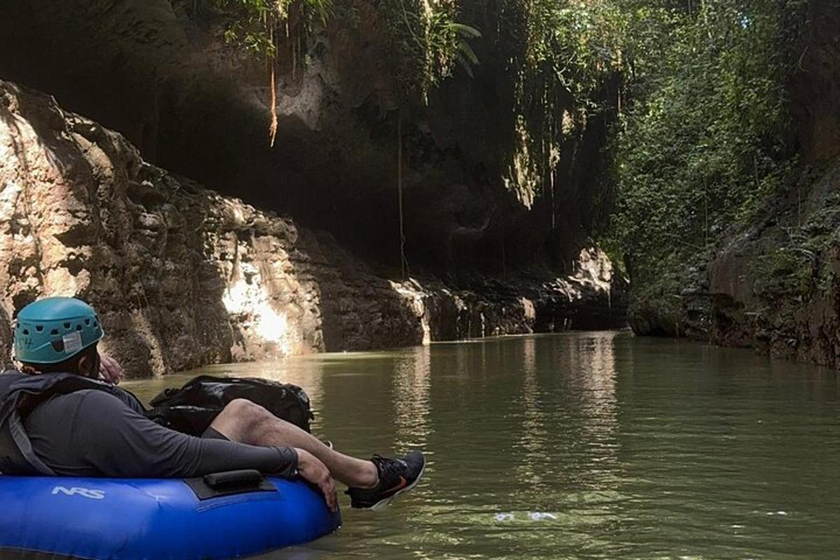 a man is sitting on a raft in a river