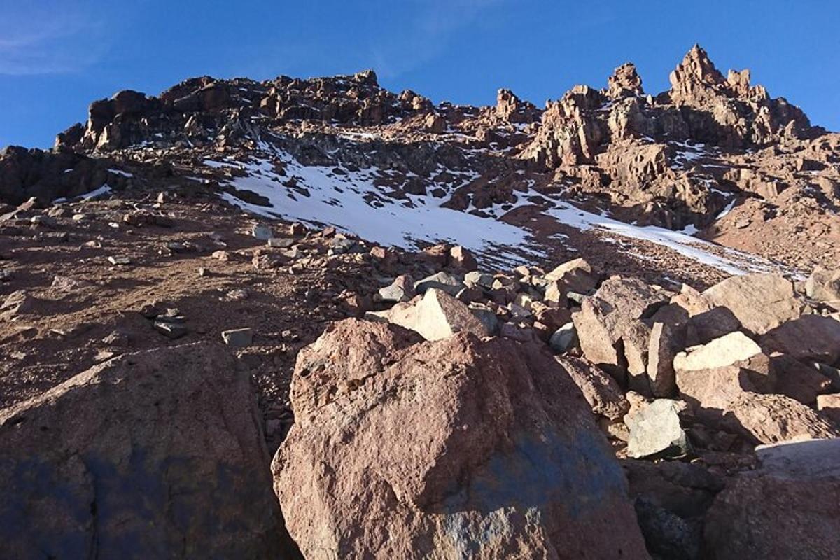 a rocky mountain with snow on top of it