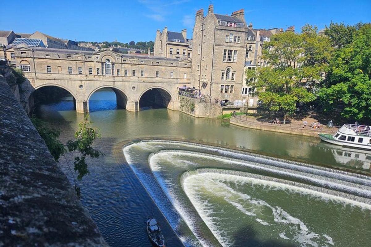 a bridge over a river with a boat in the water