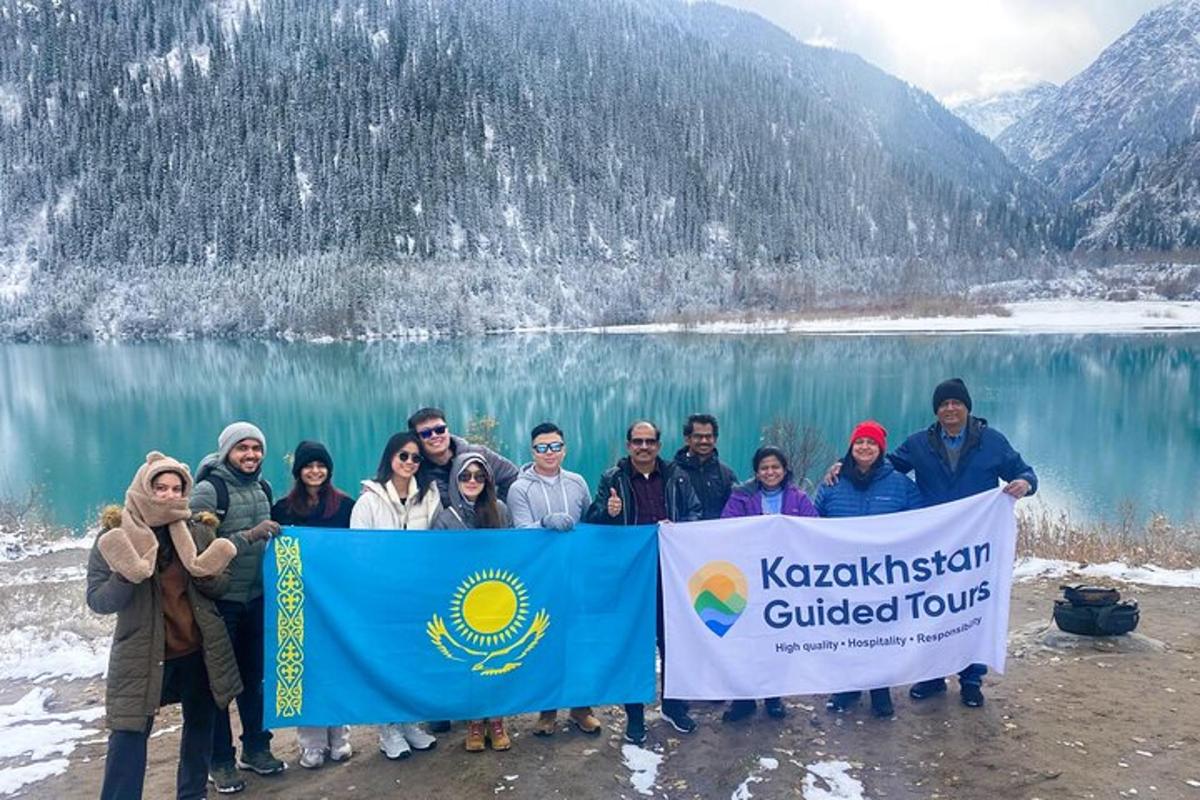 a group of people holding a banner in front of a lake
