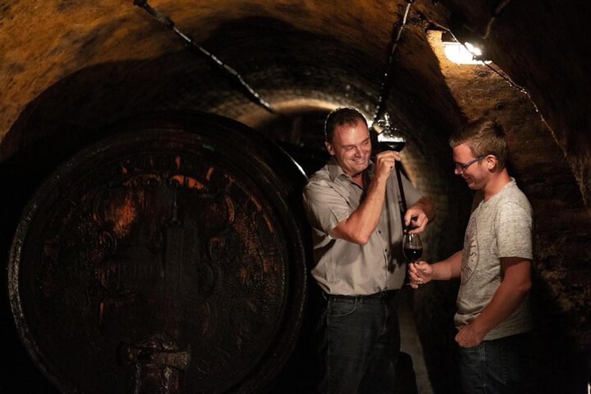 two men standing in front of a large barrel