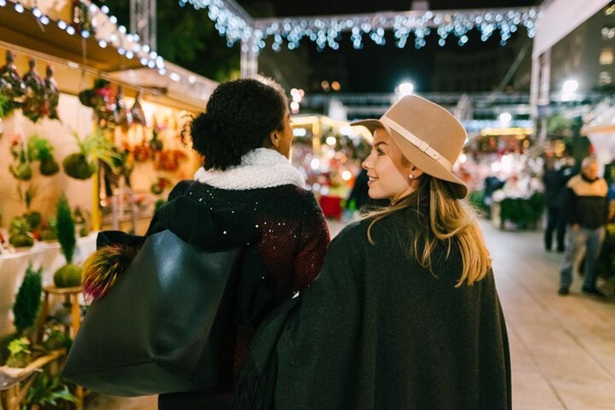 two women standing in a market looking at something