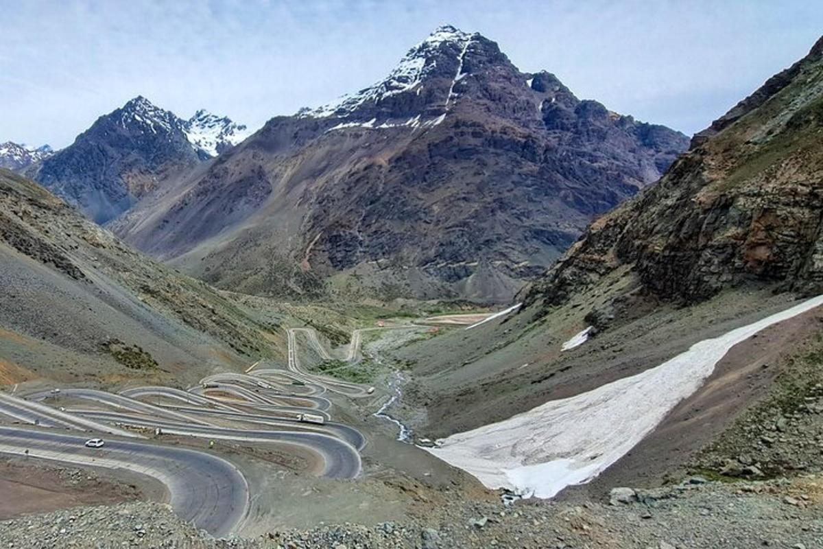 a winding road in the mountains with cars on it