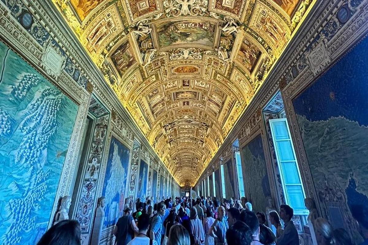a crowd of people standing in a large room with paintings